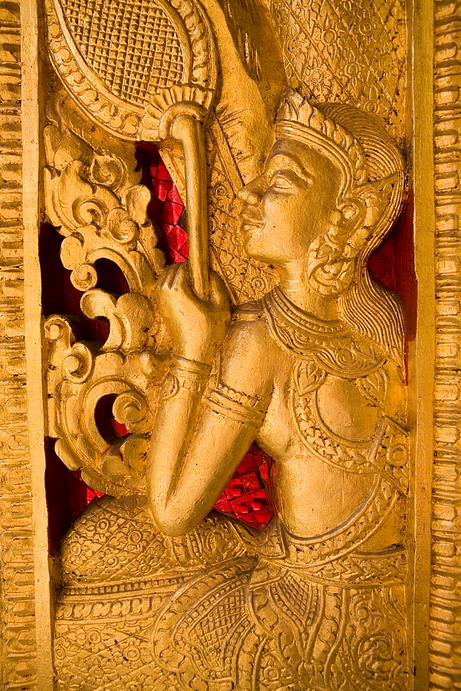 Golden buddhistic ornament at the door of the temple Ho Phra Bang, Luang Prabang, Laos