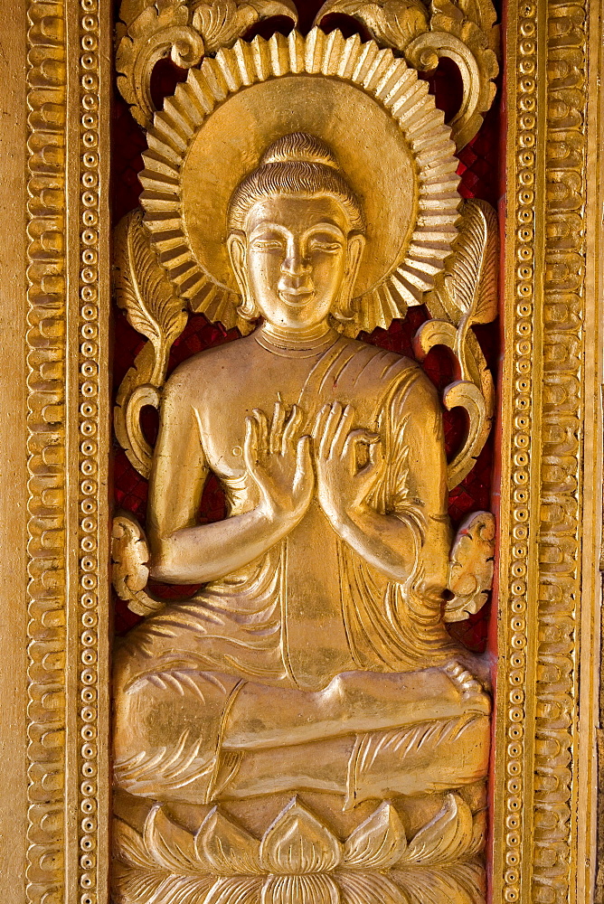 Golden buddhistic ornament at the door of the temple Ho Phra Bang, Luang Prabang, Laos