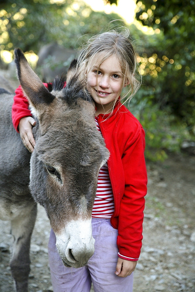 The girl with the donkey, donkey hiking in the Cevennes, France, Europe