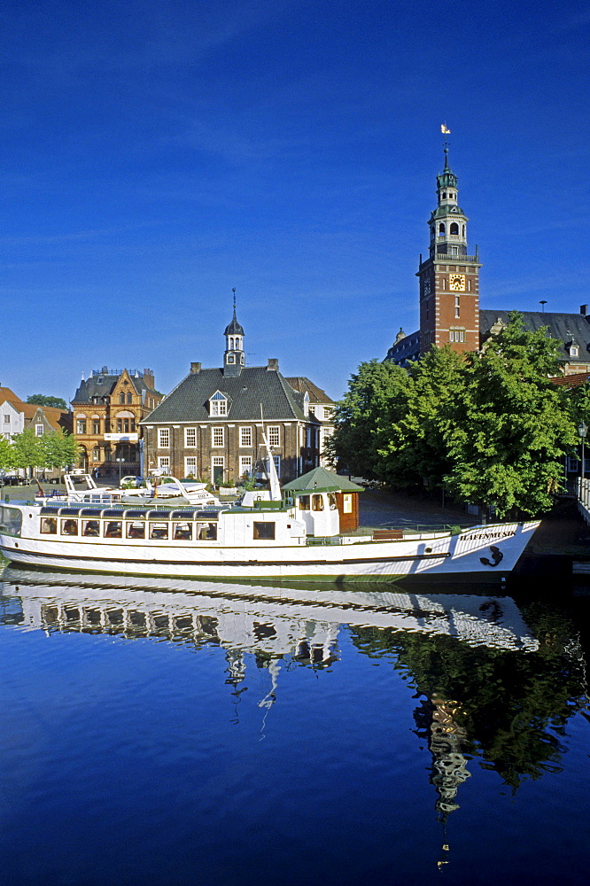 Excursion boat passing town hall and historic building Waage, Leer, Lower Saxony, Germany