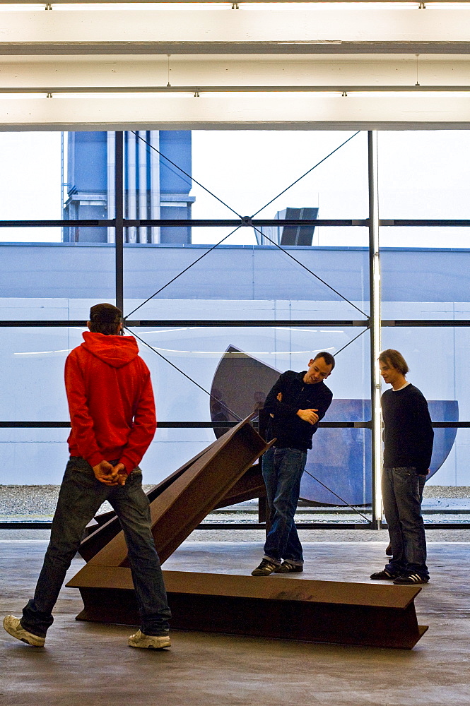 A group of young people looking at a sculpture on the Lechner Museum, Ingolstadt, Bavaria, Germany