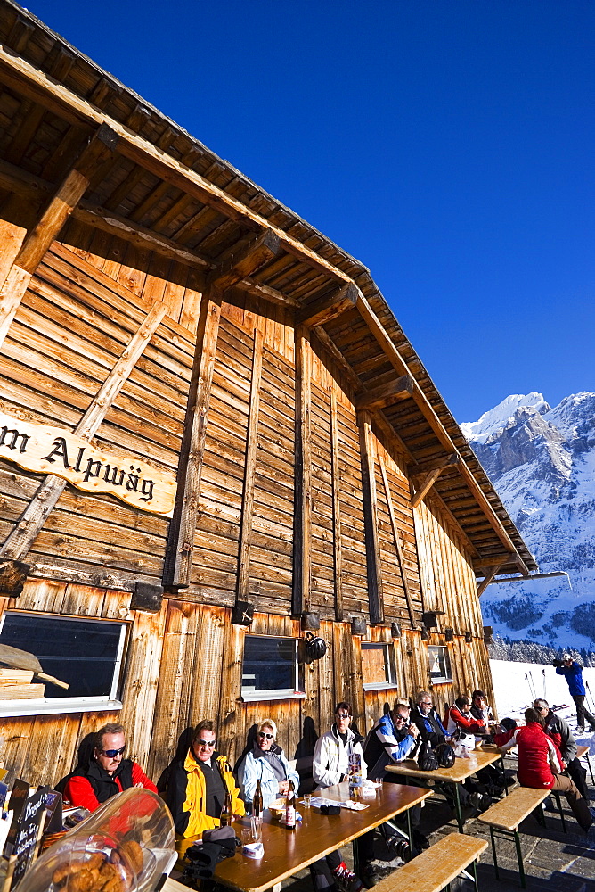 Guests resting on terrace of the chalet Alpwaeg, First, Grindelwald, Bernese Oberland, Canton of Bern, Switzerland