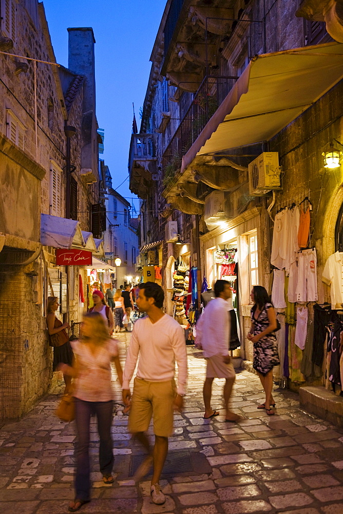 Tourists strolling though an alley at the Old Town of Hvar, Hvar Island, Dalmatia, Croatia, Europe