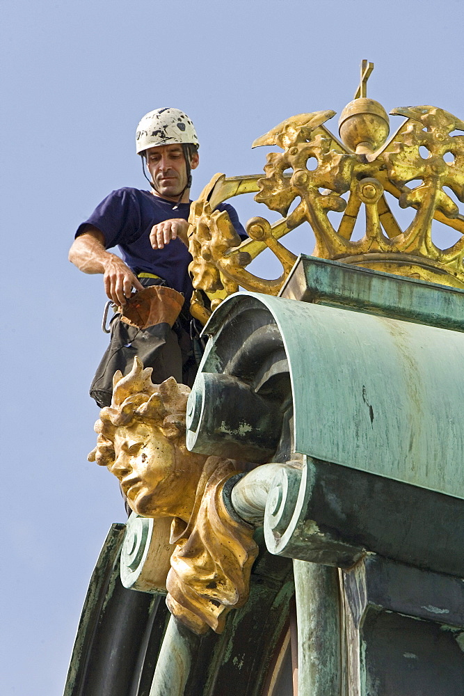 industrial climber working on dome of Charlottenburg Palace, Berlin, Germany