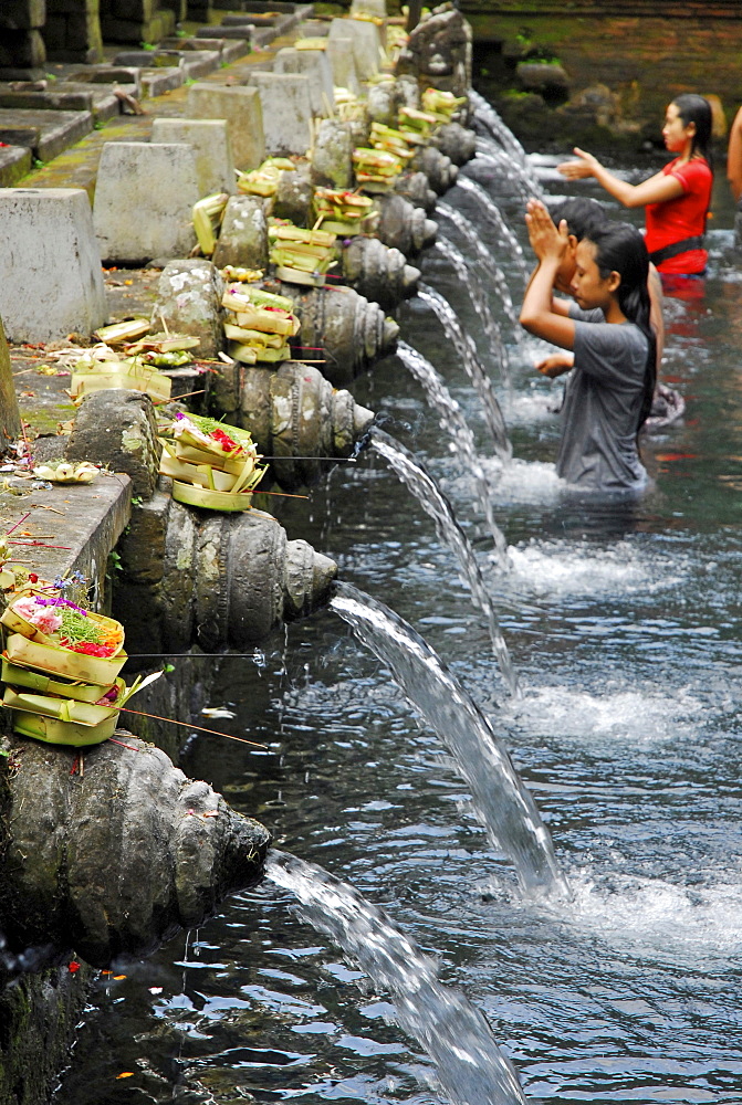 Locals in a water basin at Tirtha Empul temple, Central Bali, Indonesia, Asia