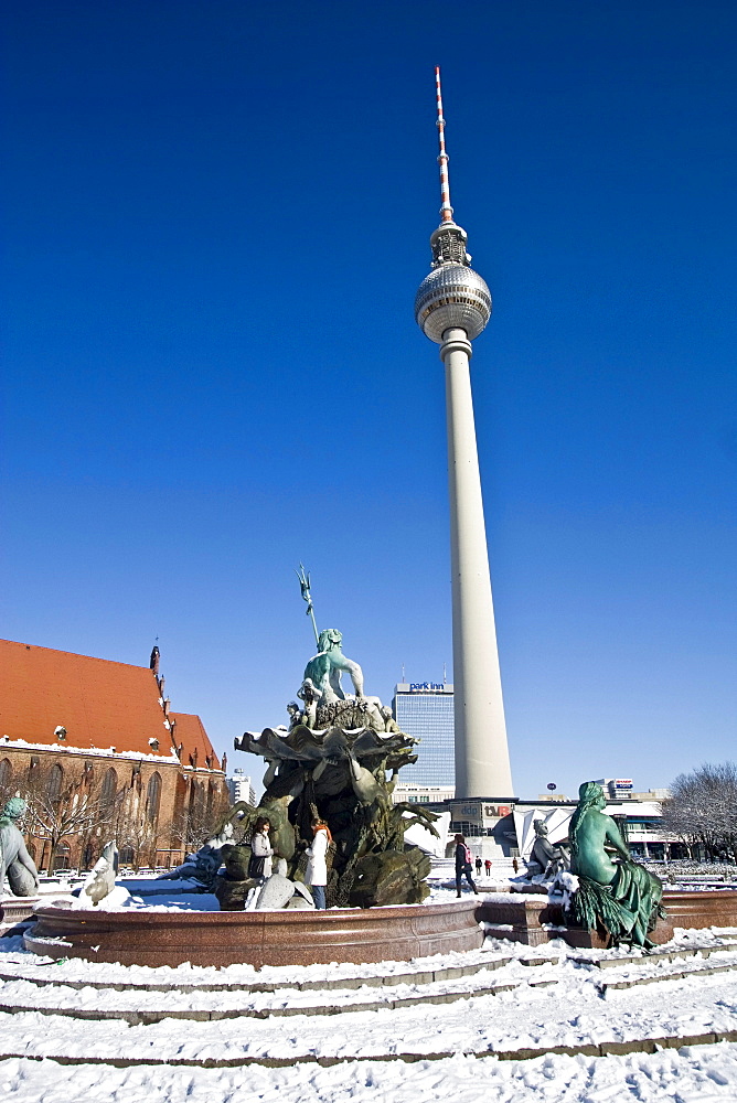 snow at Neptun fountain in front of Alex in Berlin center