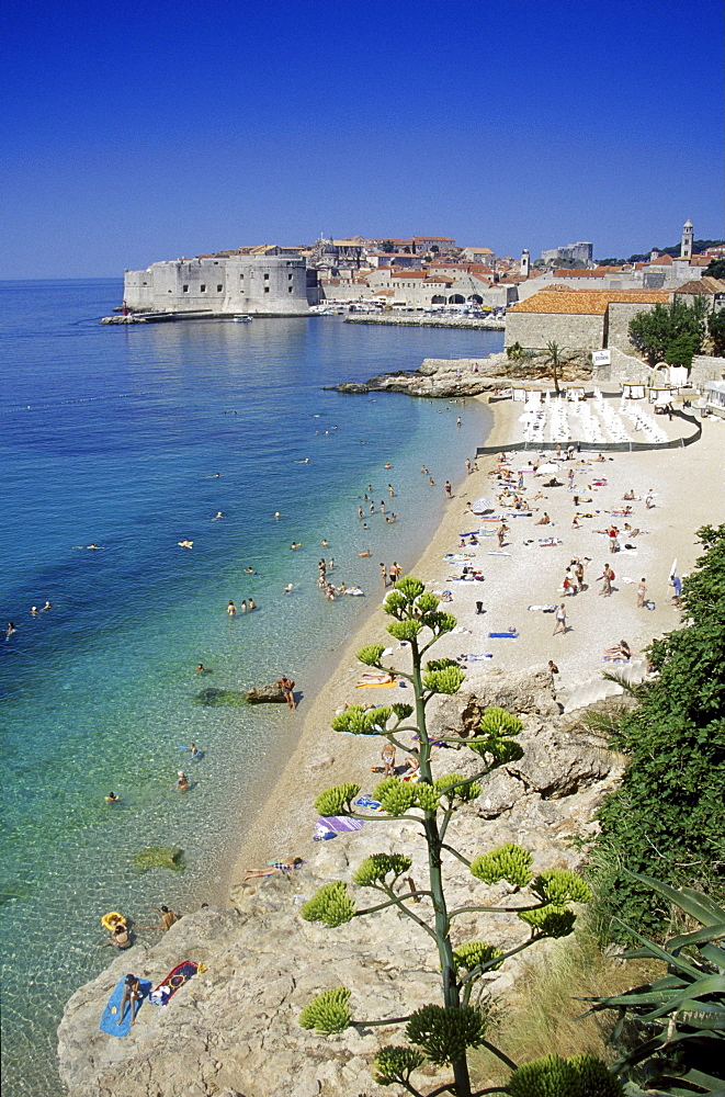 People on the beach in front of the Old Town of Dubrovnik in the sunlight, Croatian Adriatic Sea, Dalmatia, Croatia, Europe