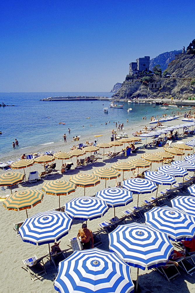 People and sunshades on the beach, medieval tower, Monterosso al Mare, Cinque Terre, Liguria, Italian Riviera, Italy, Europe