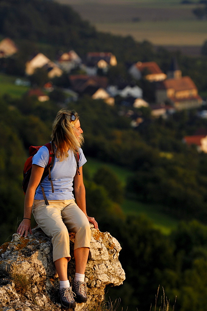 Woman on a mountain looking at the view, Walberla, Bavaria, Germany, Europe