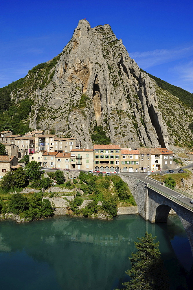 Rock formation above houses and bridge over Durance river, Sisteron, Haute Provence, France, Europe