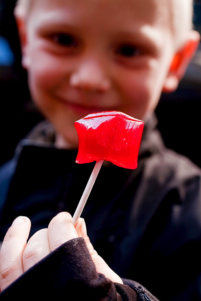 Boy with lollipop in hand, Candy factory Somods Bolcher, Copenhagen, Denmark