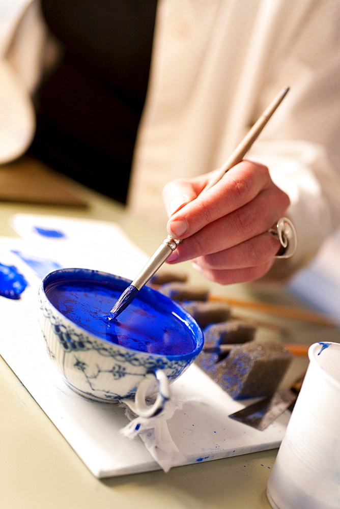 Porcelain painter in the Royal Copenhagen Flagshipstore, AmagertorvCopenhagen, Denmark