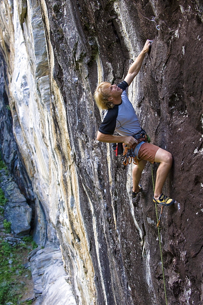 Man climbing on granite wall, Zillertal, Tyrol, Austria