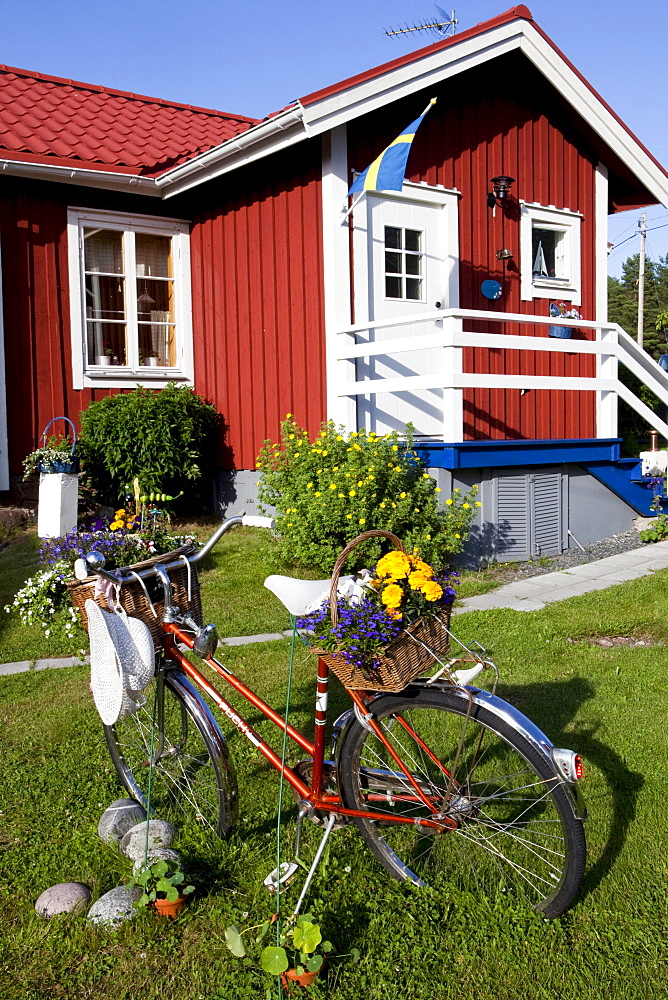 Bicycle in front of a wooden house at Norrfaellsviken, Hoega Kusten, Sweden, Europe