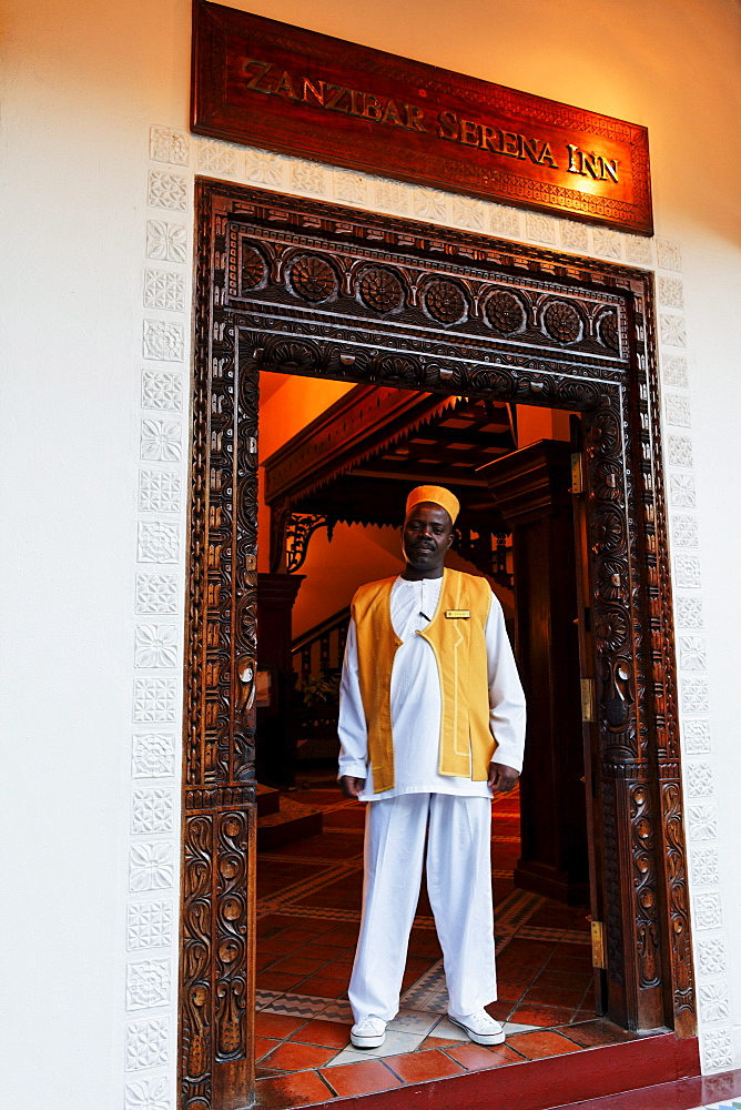 Man at the entrance of Serena Inn hotel in the evening, Stonetown, Zanzibar City, Zanzibar, Tanzania, Africa