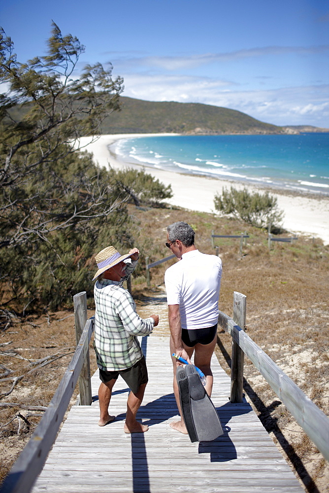 Geoff Mercer, owns a hotel and lives on Great Keppel Island, with tourist on the way to the beach, Great Keppel Island, Great Barrier Reef Marine Park, UNESCO World Heritage Site, Queensland, Australia