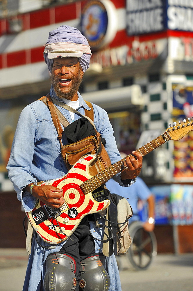 Street musician with guitar, Venice Beach, Los Angeles, California, USA