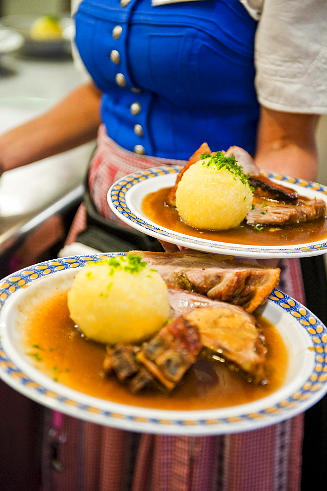 Waitress with roast pork, Weltenburg, Bavaria, Germany, Europe