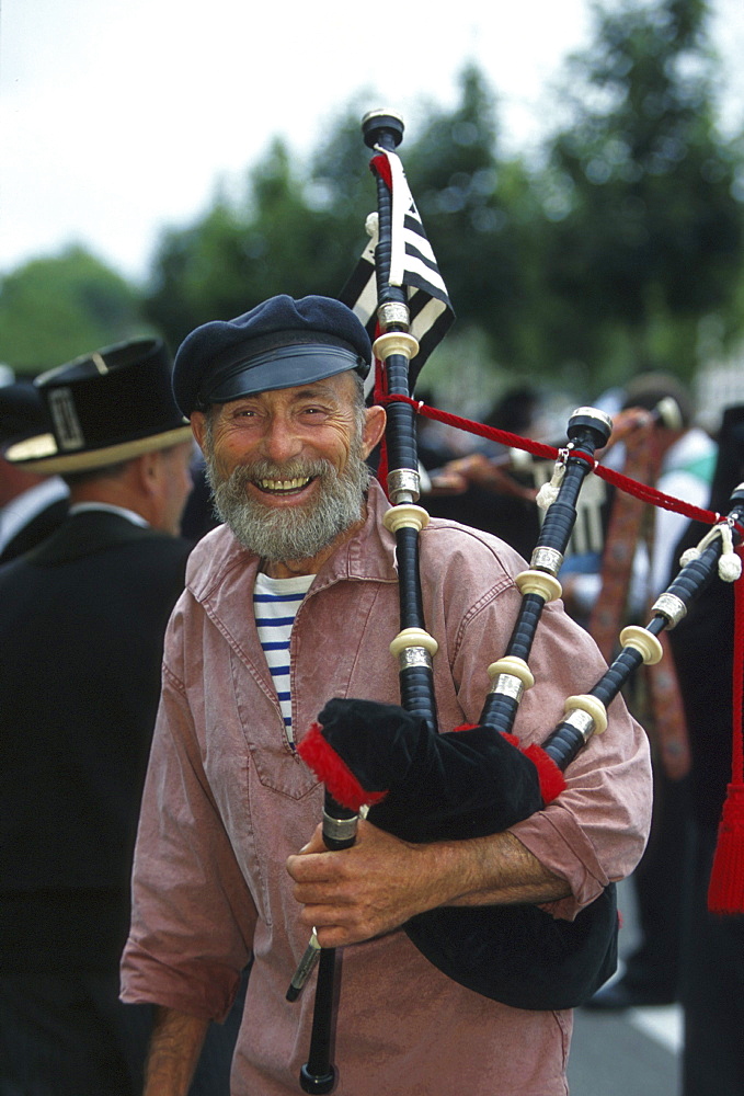 Laughing piper, Fete de la Cournaille, Quimper, Brittany, France, Europe