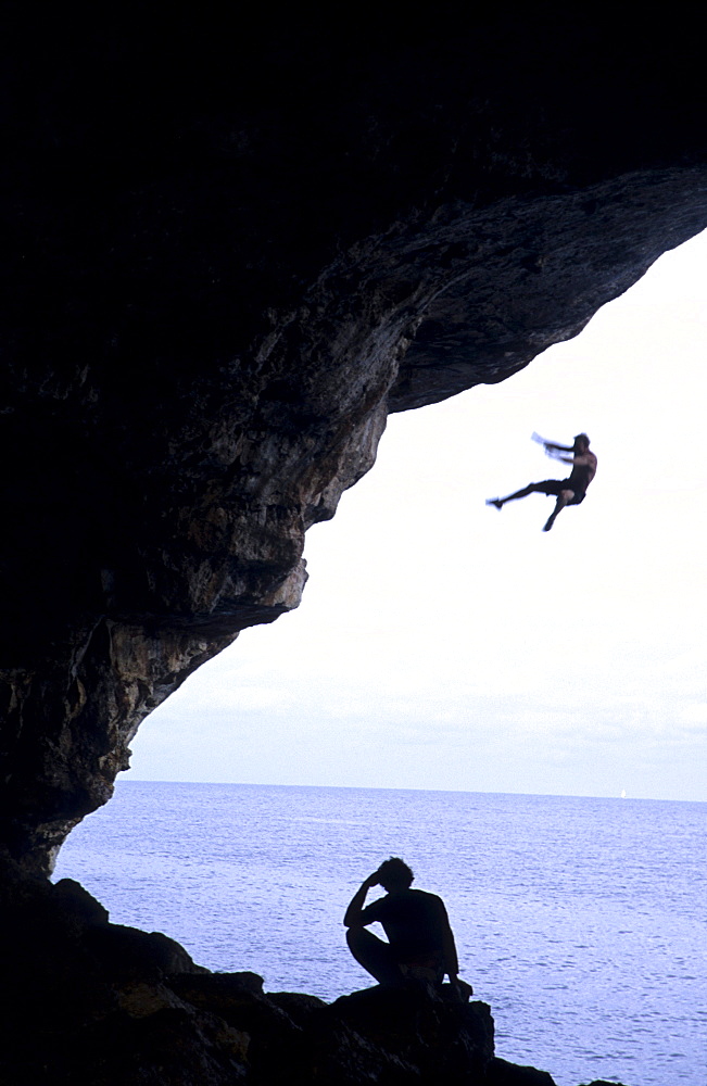 Free climber jumping into sea, Mallorca, Spain