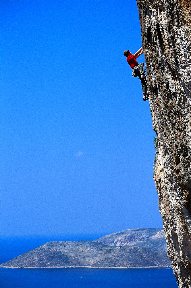 Sepp Hack rock climbing, climbing up a steep rock face, Freeclimbing, Kalymnos, Dodekanes, Greece