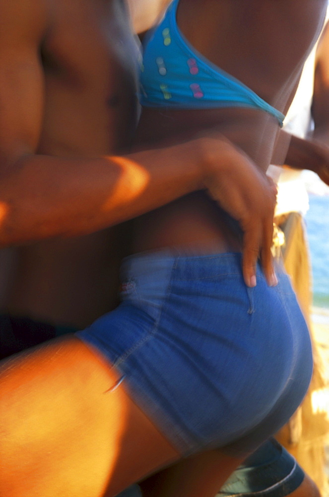 Teenagers salsa dancing on the beach, Salvador da Bahia, Brazil, South America