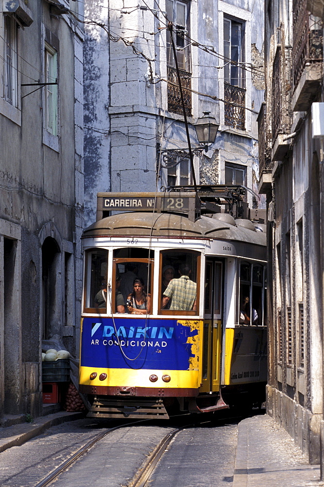 Tram in a narrow alley, Electrico 28, Alfama, Lisbon, Portugal, Europe