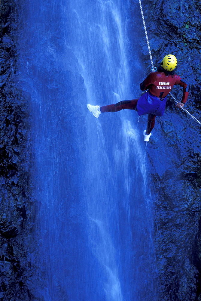 Person canyoning at Gobert Waterfall, Cilaos, La RÃˆunion, Indian Ocean