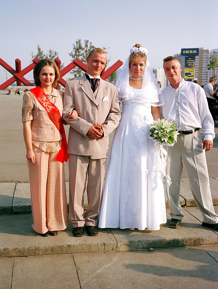 Newlyweds posing in front of the war memorial, Khimki, Moscow, Russia