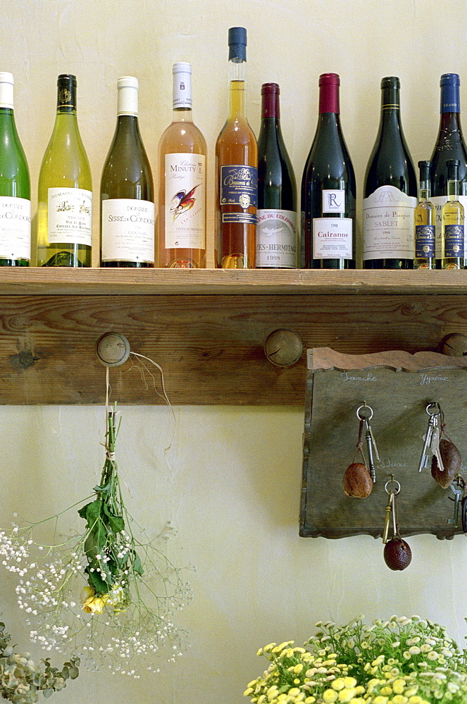 Wine bottles on a shelf at a hotel, Drome, France, Europe