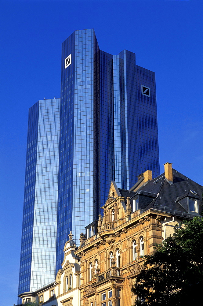 High rise building of the Deutsche Bank and residential house under blue sky, Frankfurt, Hesse, Germany, Europe