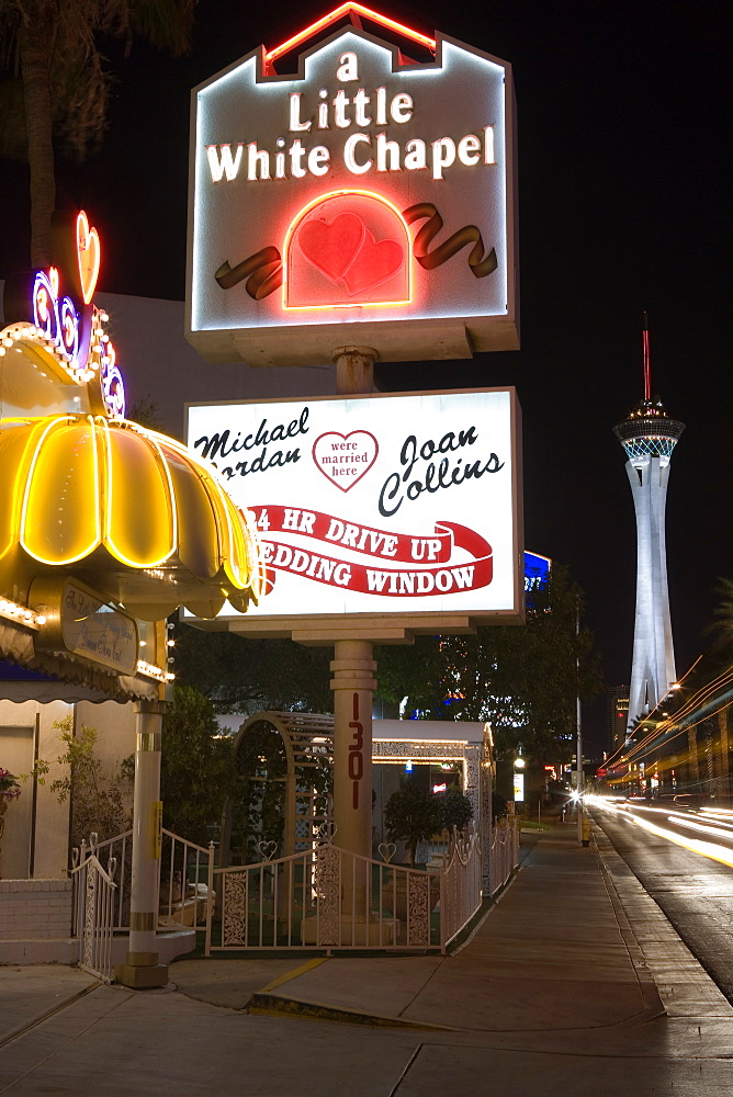 A little white chapel on Las Vegas Boulevard, The Strip. Stratosphere Tower in the background. Downtown Las Vegas, Nevada, USA