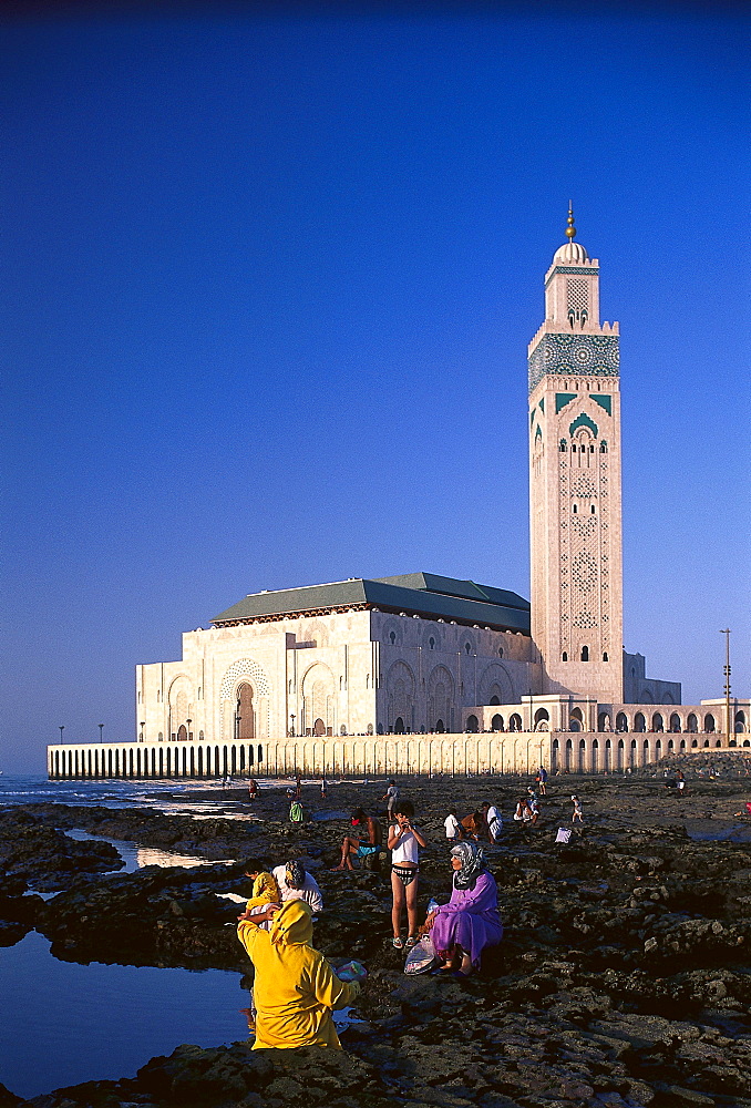 People at the reef and mosque Hassan II under blue sky, Casablanca, Morocco, Africa