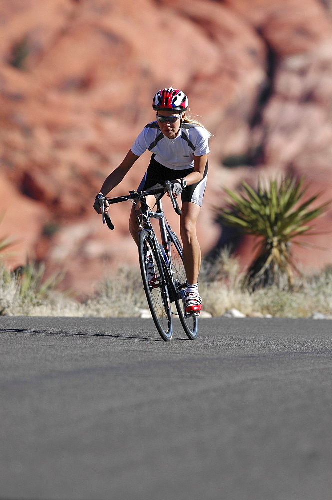 Woman on a racing bike in Zion National Park, Springdale, Utah, USA