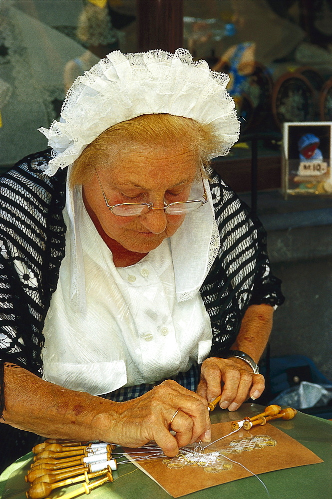 Lacemaker wearing traditional costumes, Bruges, Flanders, Belgium, Europe