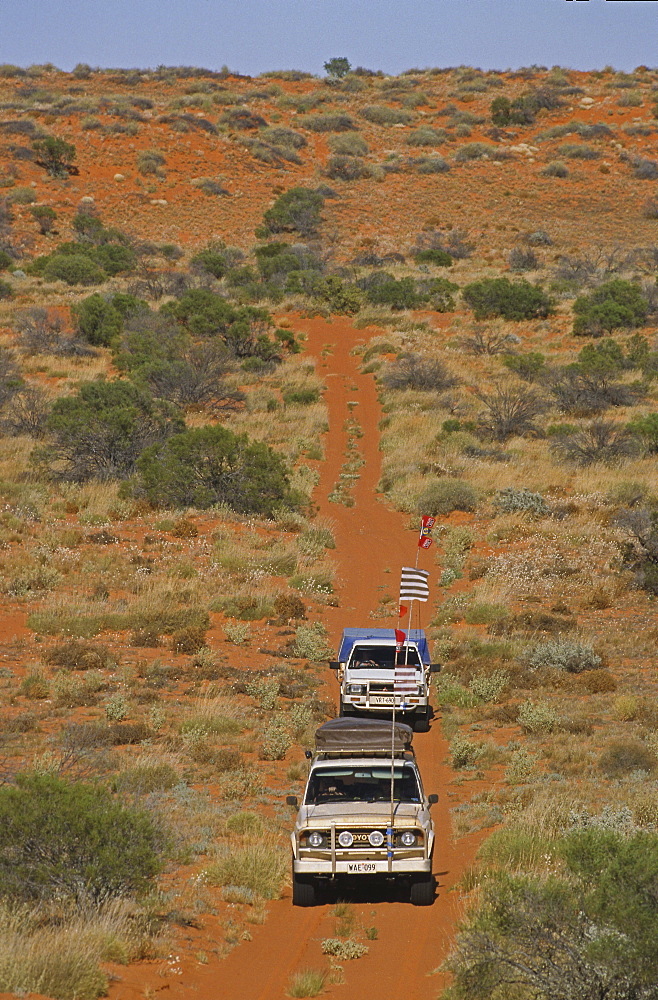 Convoy of 4WD in red sand dunes, travelling along the French Line, Simpson Desert, Queensland, Australia