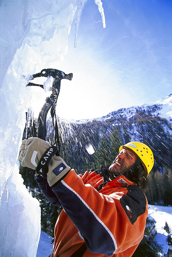 Man with ice axe in front of an ice face, Sand in Taufers, South Tyrol, Italy, Europe