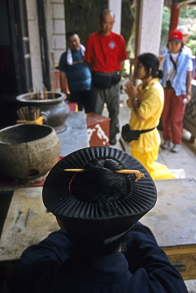 Taoist monk wears his long hair in a bun under his hat, in monastery, Hua Shan, Shaanxi province, Taoist mountain, China, Asia