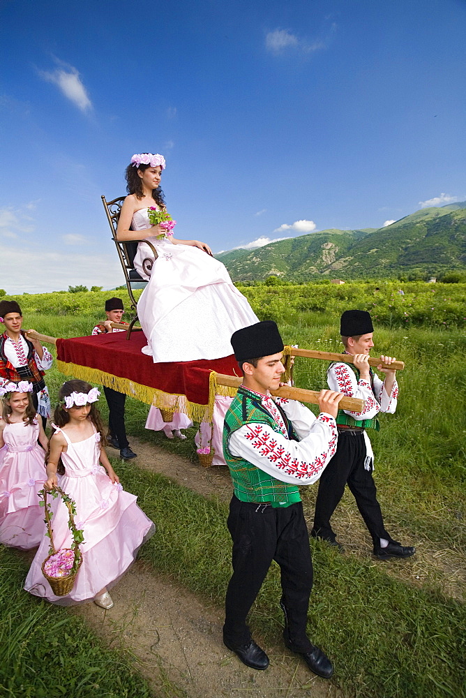 Rose Queen, young woman is carried in a sedan, Rose Festival, Karlovo, Bulgaria, Europe