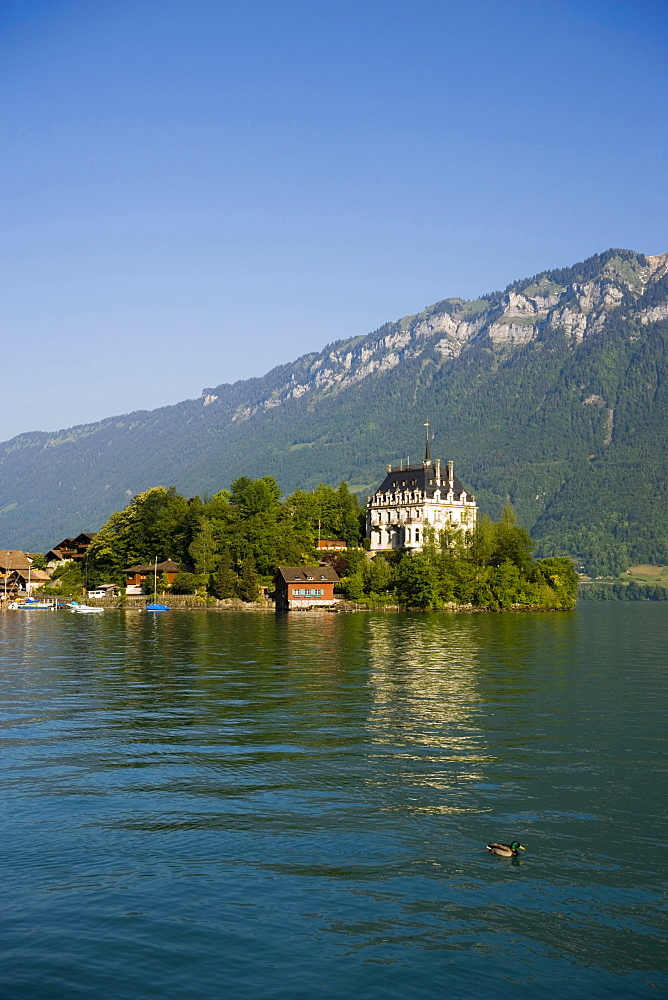 View over Lake Brienz to castle Seeburg, Iseltwald, Bernese Oberland (highlands), Canton of Bern, Switzerland