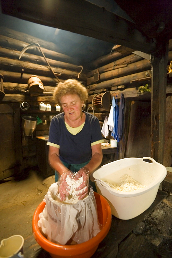 Anna Gruber kneading the cheese, traditional cheese production, Karseggalm (1603 m, one of the oldest mountain hut in the valley), Grossarl Valley, Salzburg, Austria