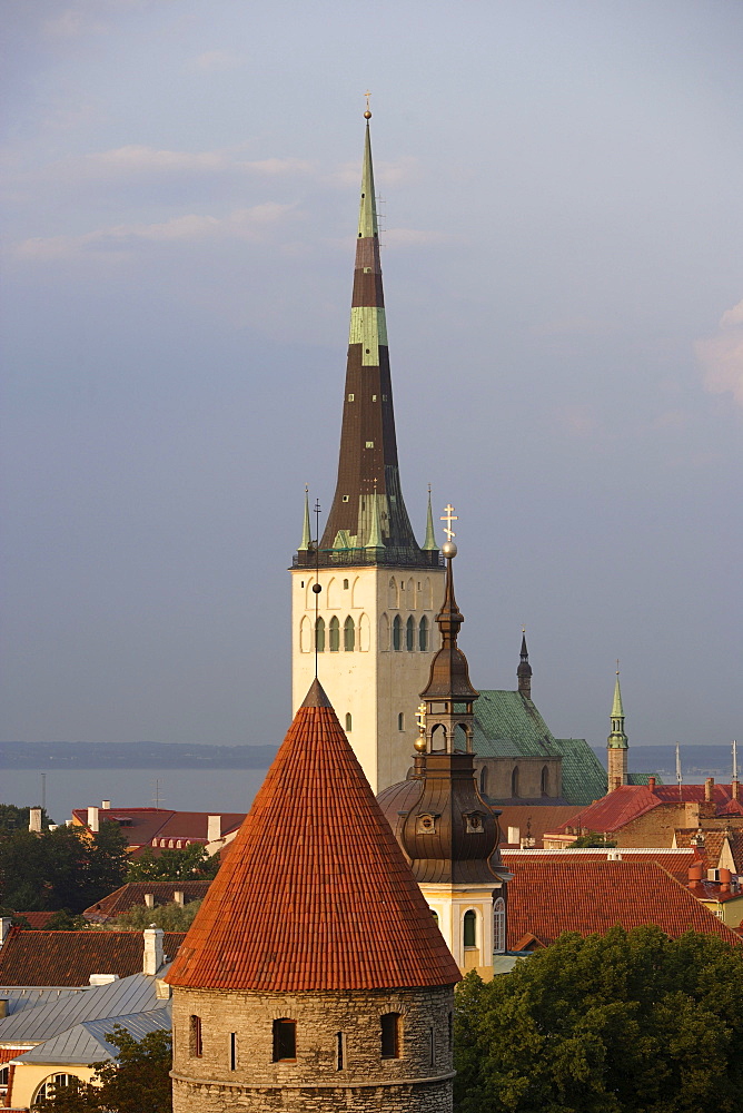 View over the old town of Tallinn seen from Rohukohtu terrace. One of the tower of the city walls in the front, St. Michael's monastery and St. Olaf's Church in the back, Tallinn, Estonia