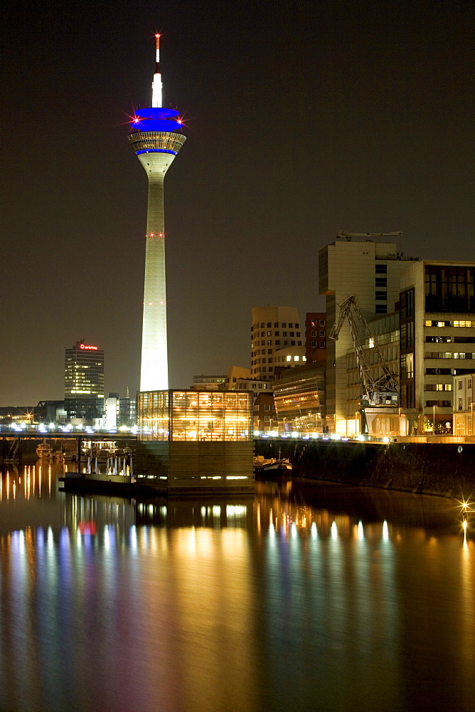 Modern architecture of the Media Harbour at night with television tower, Neuer Zollhof, Duesseldorf, state capital of NRW, North-Rhine-Westphalia, Germany