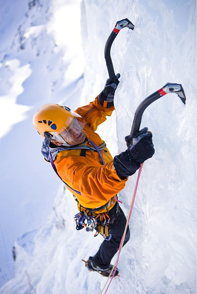 A man ice climbing on on a frozen waterfall, Corn Diavolezza near Pontresina, Grisons, Switzerland