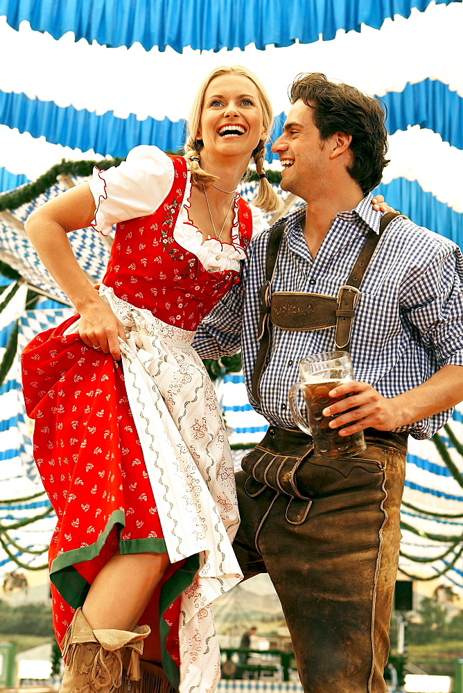 Couple dancing on table in a beer tent