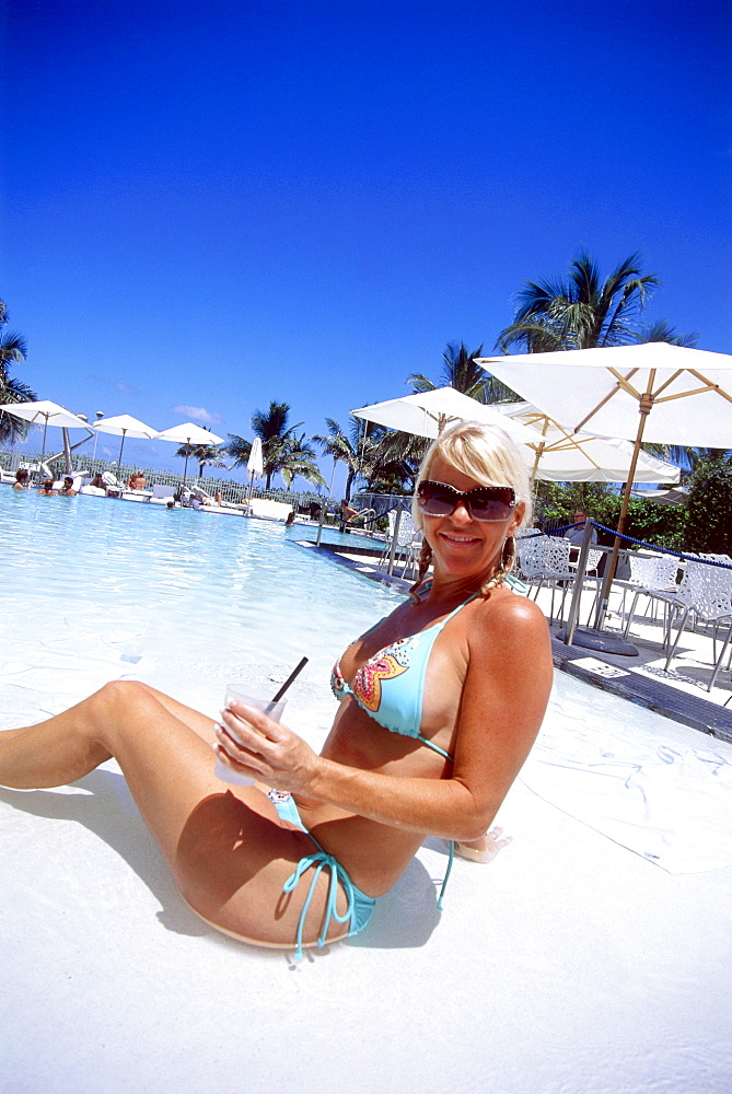 Girl with cocktail at Swimming Pool, South Beach, Miami, Florida, USA