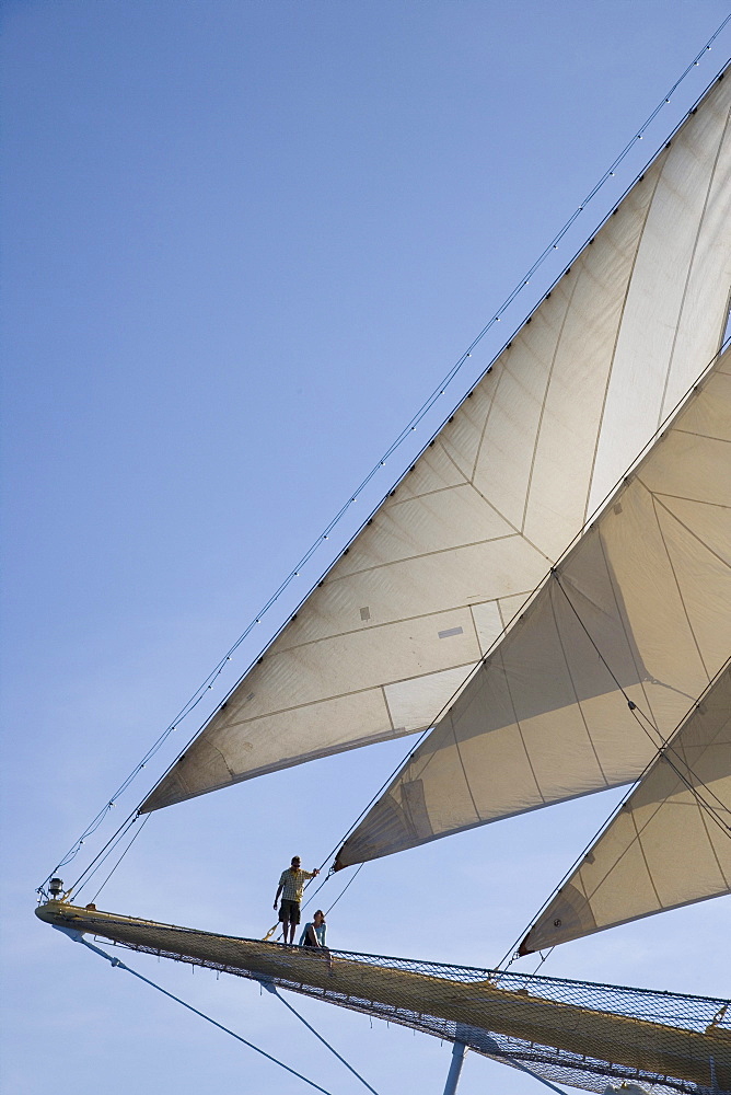 Couple on Royal Clipper Bowsprit, Mediterranean Sea, near Lipari, Sicily, Italy