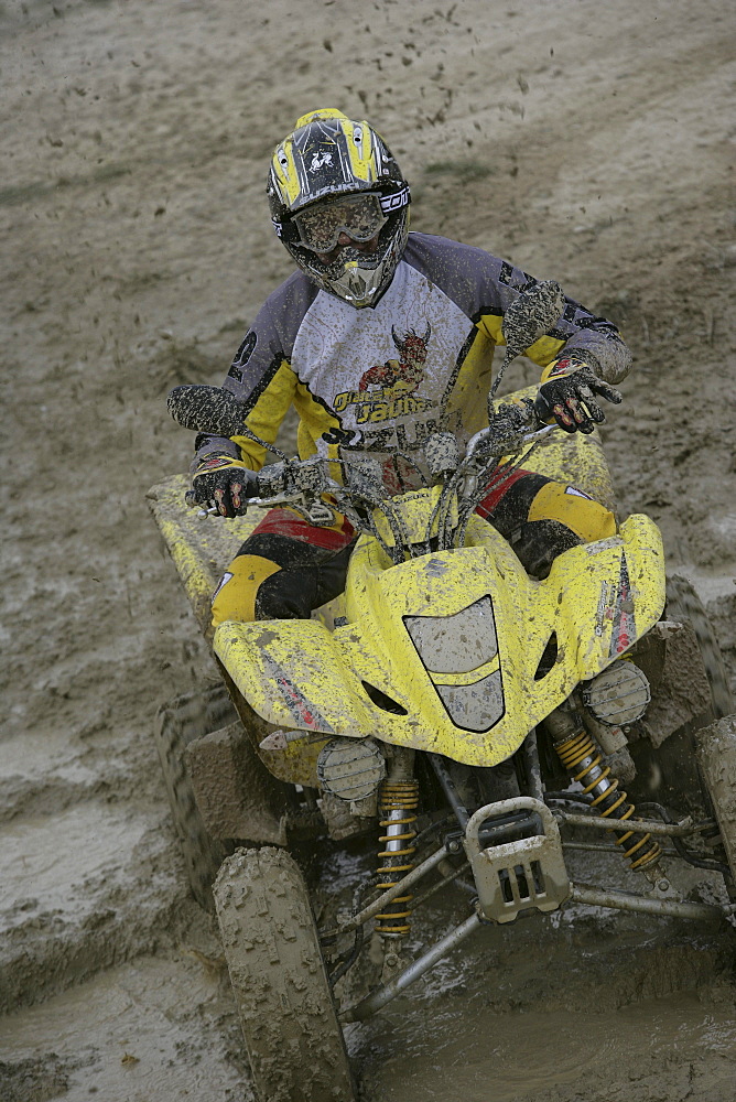 Man driving Suzuki Quad through mud, Test Grounds, Suzuki Offroad Camp, Valencia, Spain