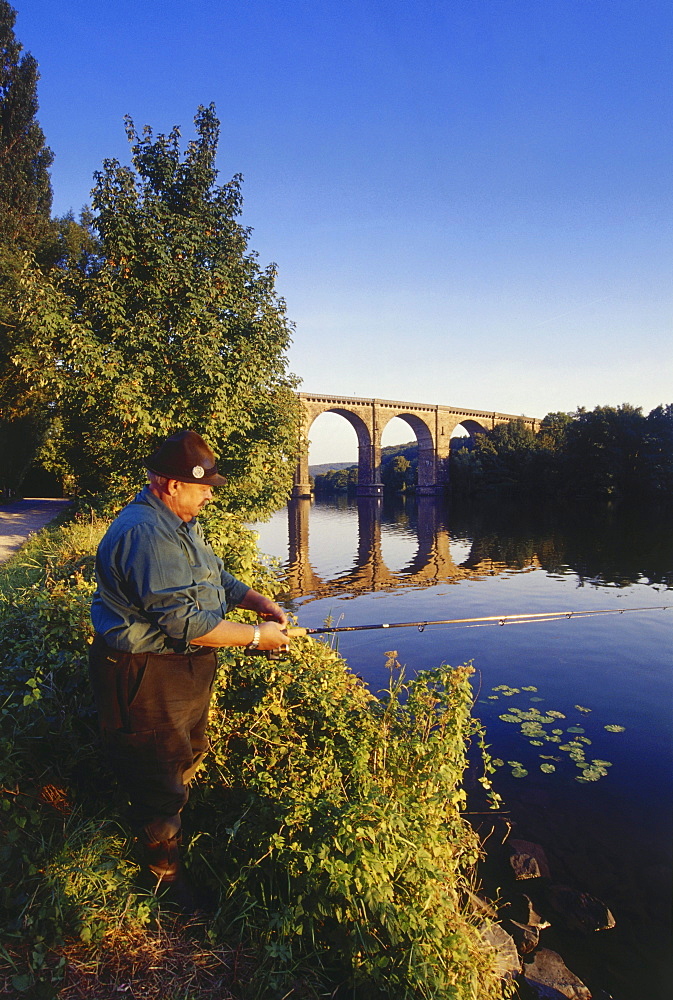 Angler fishing, Railway viaduct in the background, Herdecke, Ruhr Valley, Ruhr, Northrhine Westphalia, Germany