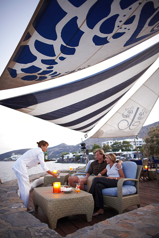 Couple at a beach bar in the evening, Elounda, Agios Nikolaos, Crete, Greece